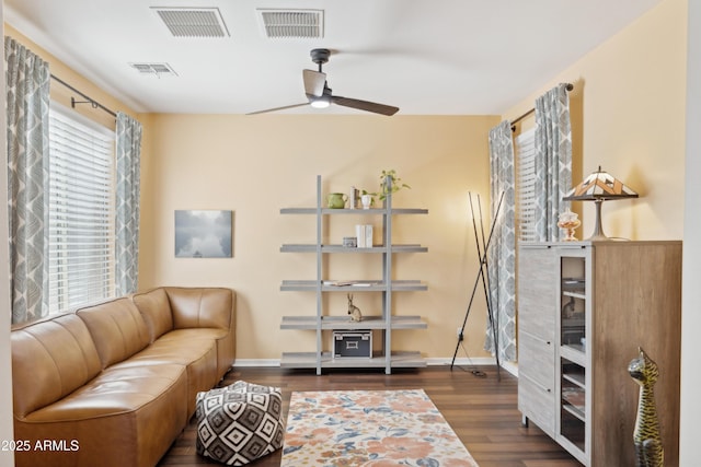 sitting room featuring a ceiling fan, wood finished floors, and baseboards