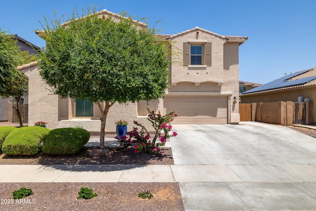 view of front of home with driveway, stucco siding, fence, a garage, and a tile roof