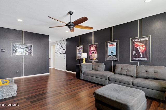 living room featuring an accent wall, a ceiling fan, recessed lighting, wood finished floors, and baseboards