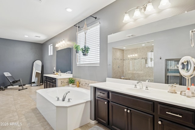 full bath with walk in shower, plenty of natural light, a bath, and vanity