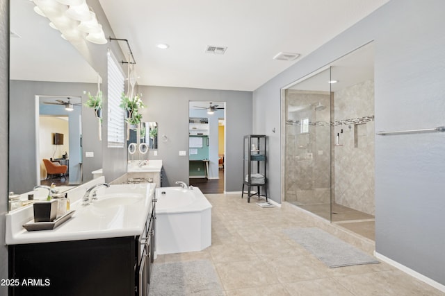full bath with ceiling fan, walk in shower, a bath, and two vanities