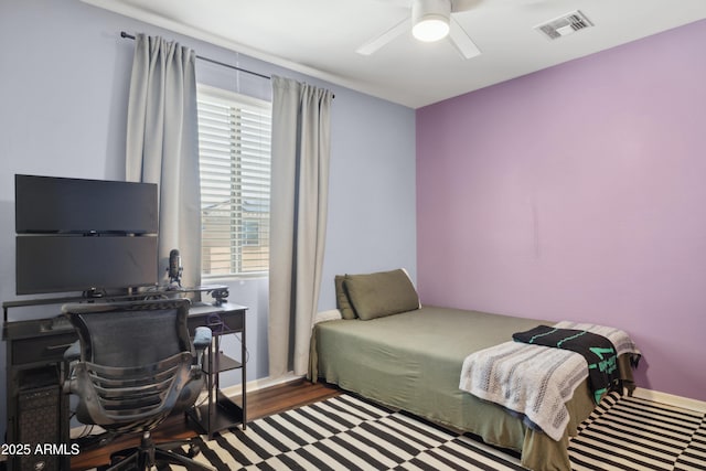 bedroom featuring a desk, wood finished floors, and a ceiling fan