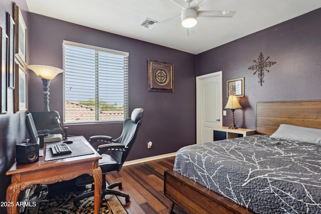 bedroom featuring wood finished floors, a desk, and baseboards