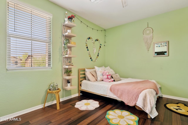 bedroom with wood finished floors and baseboards
