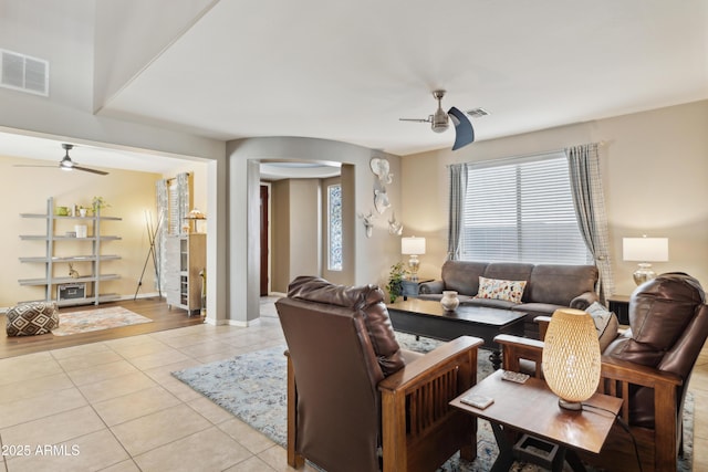 living room featuring ceiling fan, light tile patterned flooring, and baseboards