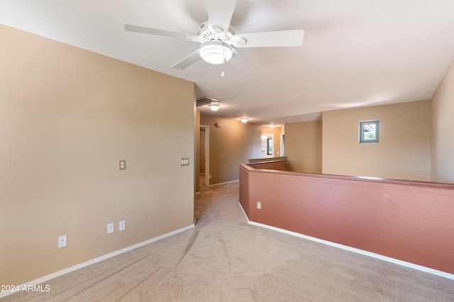 carpeted empty room featuring ceiling fan