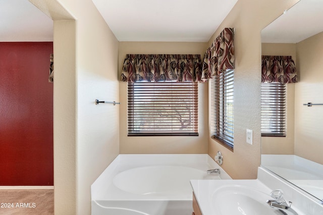 bathroom featuring vanity and a washtub