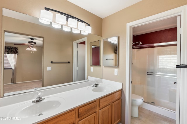 bathroom with toilet, tile patterned flooring, vanity, an enclosed shower, and ceiling fan