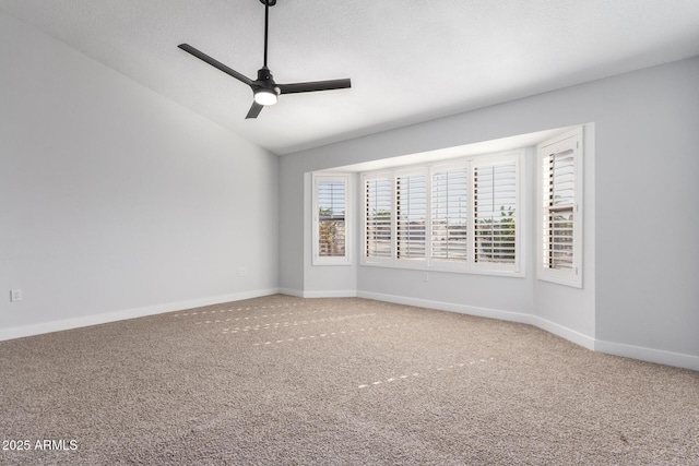 carpeted empty room with lofted ceiling and ceiling fan