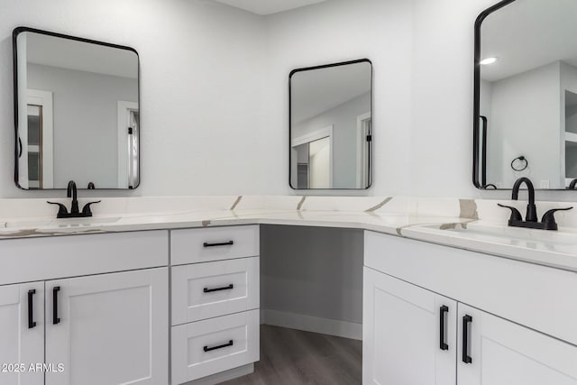 bathroom with hardwood / wood-style flooring and vanity