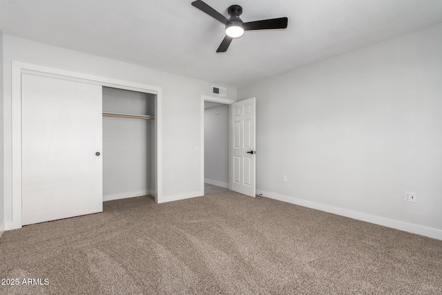 unfurnished bedroom featuring carpet flooring, ceiling fan, and a closet