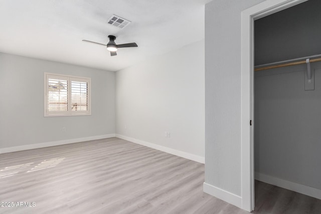 unfurnished bedroom featuring ceiling fan, light hardwood / wood-style flooring, and a closet