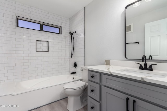 full bathroom featuring vanity, toilet, tiled shower / bath combo, and wood-type flooring