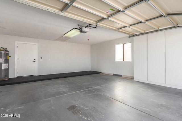 garage featuring a garage door opener and electric water heater