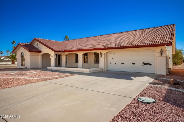 mediterranean / spanish-style home with a garage