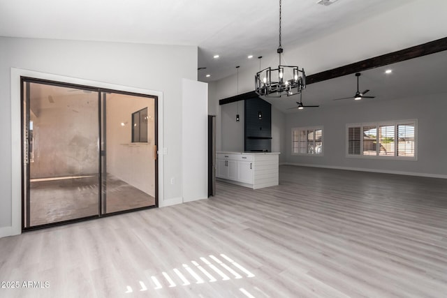 unfurnished living room featuring ceiling fan with notable chandelier, lofted ceiling, and light hardwood / wood-style floors