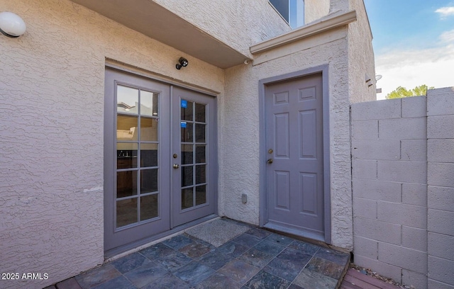 19601 N 7th St Unit 1003, Phoenix, AZ 85024 - view of exterior entry with french doors and stucco siding