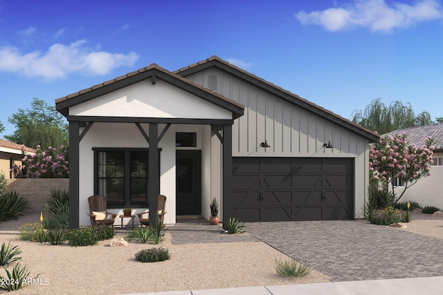 view of front of house featuring covered porch and a garage