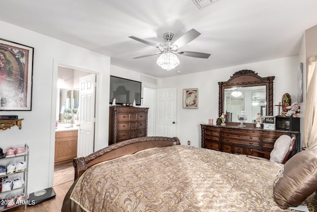 bedroom featuring ensuite bathroom, ceiling fan, and light hardwood / wood-style floors