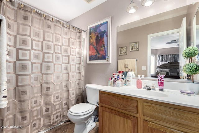 bathroom featuring vanity, curtained shower, and toilet