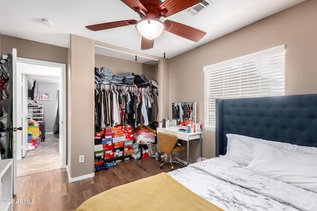 bedroom featuring ceiling fan, a closet, and hardwood / wood-style flooring