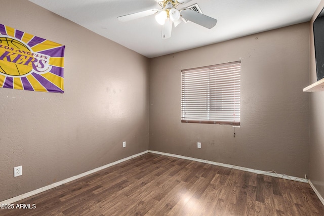 empty room featuring dark hardwood / wood-style flooring and ceiling fan