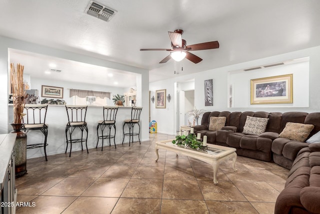 tiled living room featuring ceiling fan