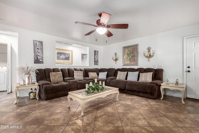 living room featuring washer / dryer and ceiling fan