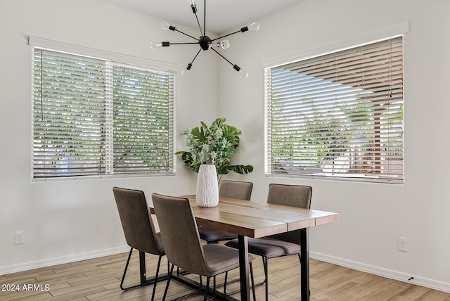 dining space with an inviting chandelier and light wood-type flooring