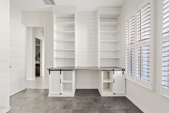 spacious closet with a barn door