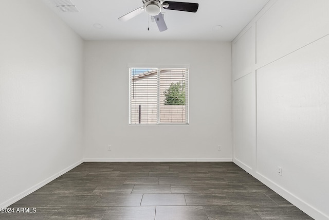 spare room featuring ceiling fan and dark wood-type flooring