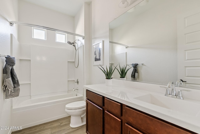 full bathroom with wood-type flooring, shower / bathing tub combination, vanity, and toilet