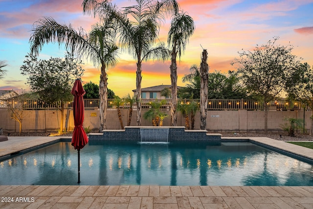 pool at dusk with pool water feature