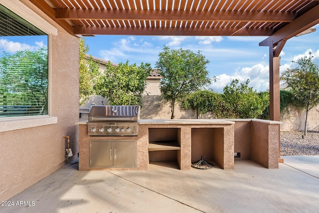 view of patio with a grill, area for grilling, and a pergola