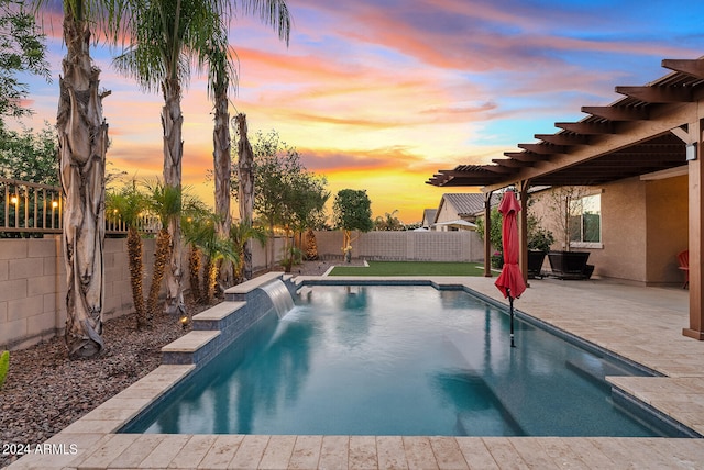 pool at dusk featuring a patio area and pool water feature