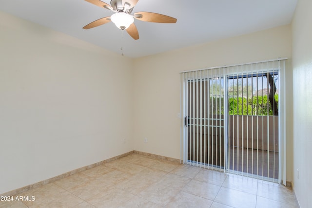 tiled spare room featuring ceiling fan