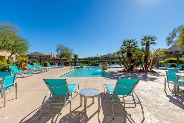 view of swimming pool with a patio and pool water feature