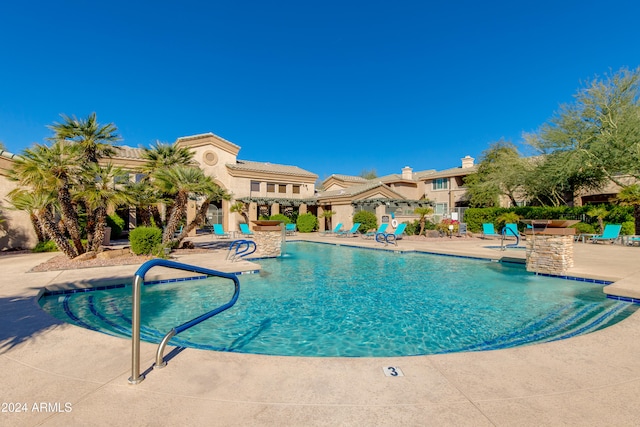 view of swimming pool featuring a patio area