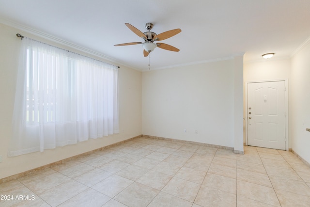 tiled spare room featuring crown molding and ceiling fan