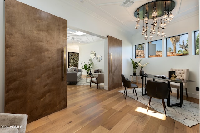 interior space featuring an inviting chandelier and light hardwood / wood-style flooring