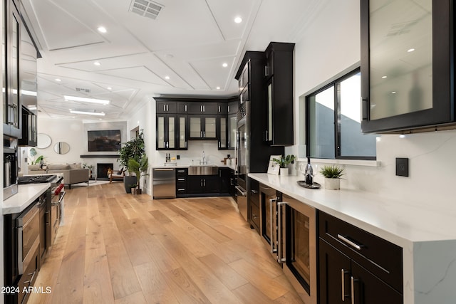 kitchen with stainless steel appliances, light hardwood / wood-style flooring, wine cooler, sink, and coffered ceiling