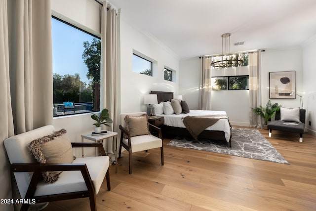 bedroom featuring light hardwood / wood-style floors and crown molding