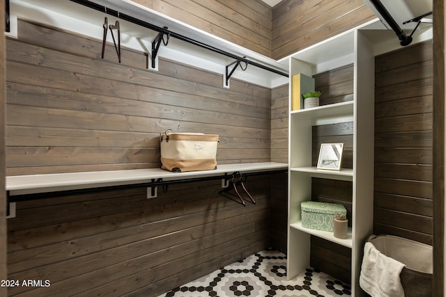 spacious closet with light tile floors