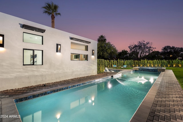 view of pool at dusk