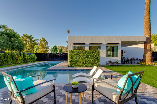 view of swimming pool with a patio area and a lawn