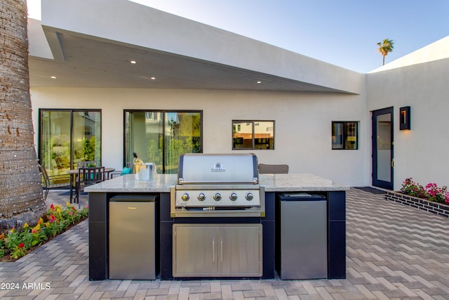 view of terrace featuring an outdoor kitchen and grilling area