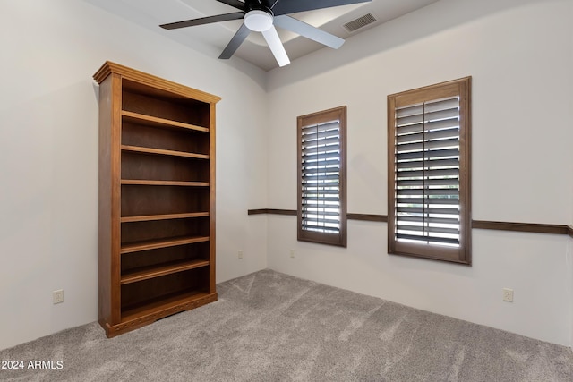 interior space with ceiling fan and light colored carpet