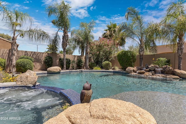 view of pool with an in ground hot tub