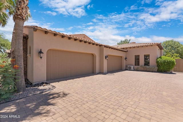 mediterranean / spanish-style house with a garage