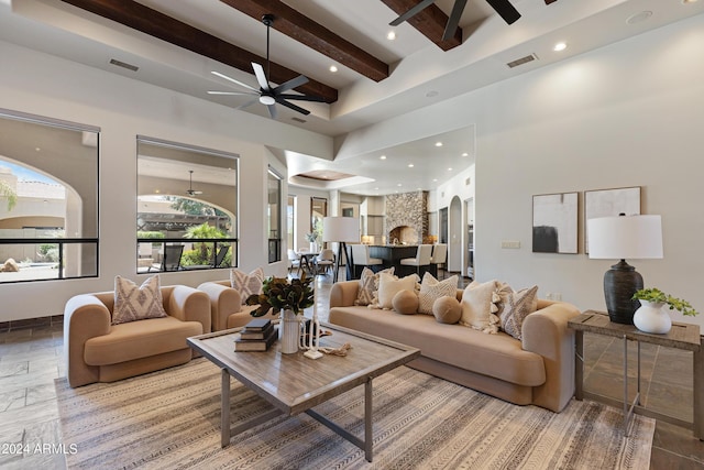 living room with beam ceiling and ceiling fan